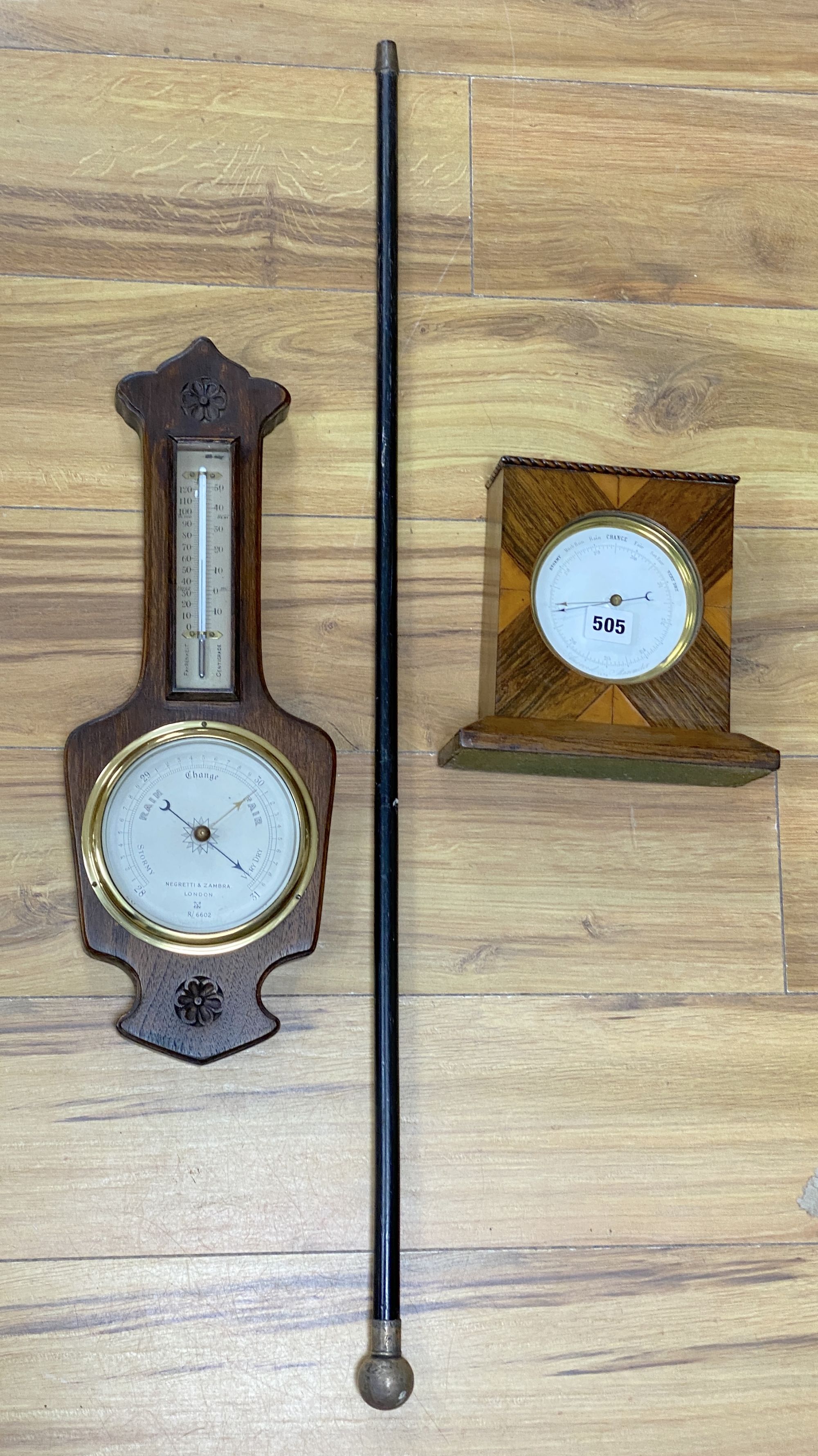 A Victorian silver mounted cane, a wheel barometer and a mantel barometer